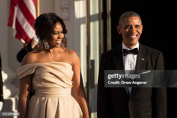 First Lady Michelle Obama and U.S. President Barack Obama wait for leaders to arrive for the Nordic state dinner on the North Portico at the White...
