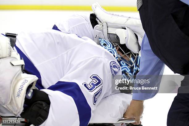 Ben Bishop of the Tampa Bay Lightning is carted off the ice after a play at the net during the first period against the Pittsburgh Penguins in Game...