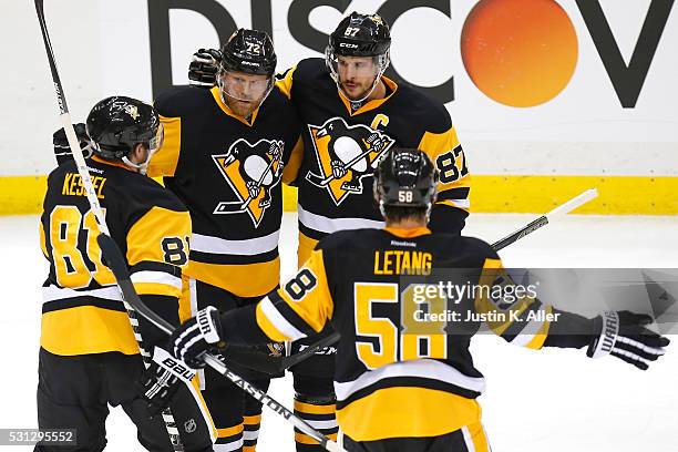 Patric Hornqvist of the Pittsburgh Penguins celebrates with his teammates Phil Kessel, Sidney Crosby and Kris Letang after scoring a goal against...