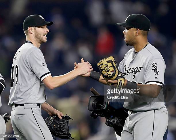 Chris Sale of the Chicago White Sox is congratulated by teammate Jose Abreu after the game against the New York Yankees at Yankee Stadium on May 13,...