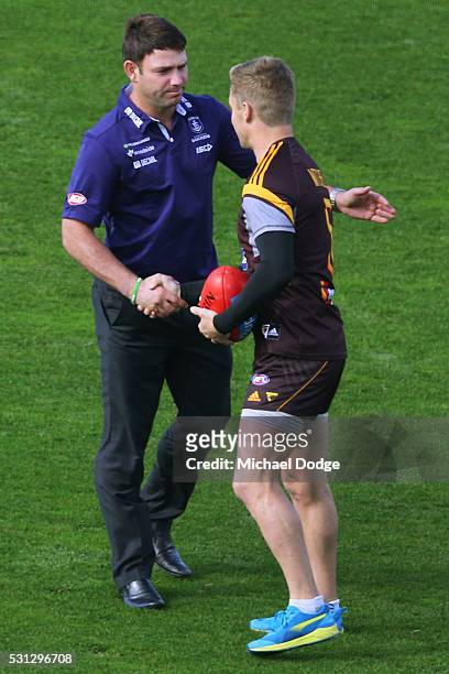 Dockers assistant coach Brent Guerra catches up with former teammate Sam Mitchell of the Hawks before warm up during the round eight AFL match...