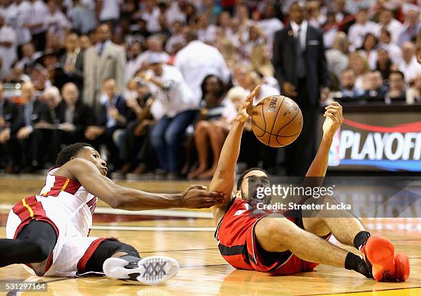 Josh Richardson of the Miami Heat tries to grab a loose ball against Cory Joseph of the Toronto Raptors during Game 6 of the Eastern Conference...