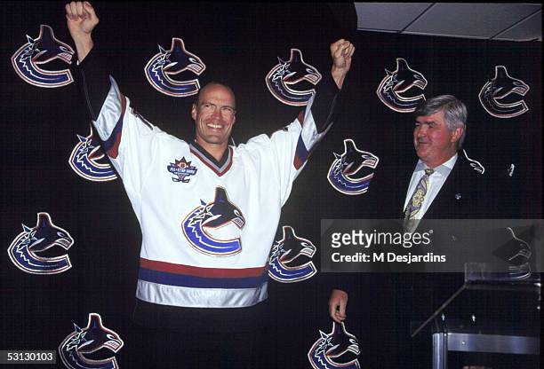 Mark Messier with Vancouver GM Pat Quinn after signing three year deal with Canucks while leaving New York behind.