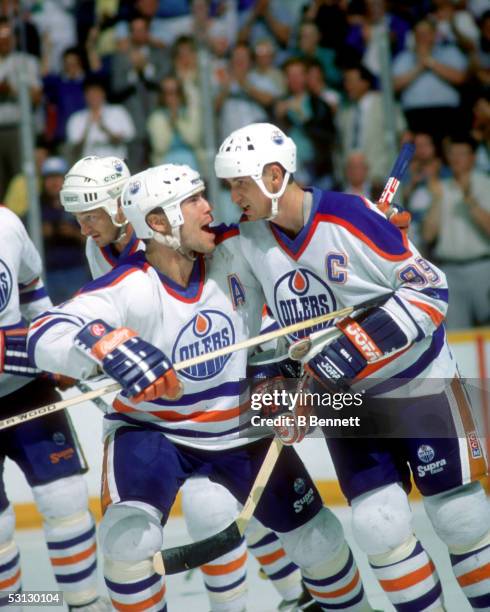 Mark Messier of the Edmonton Oilers celebrates with his teammate Wayne Gretzky during the 1988 Stanley Cup Finals against the Boston Bruins in May,...