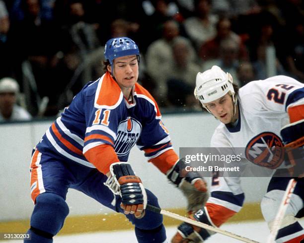 Mark Messier battles with Mike Bossy.