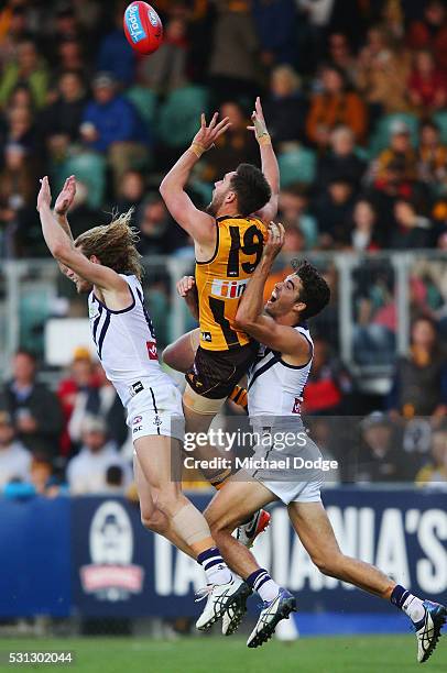 Jack Gunston of the Hawks competes for the ball over David Mundy of the Dockers during the round eight AFL match between the Hawthorn Hawks and the...