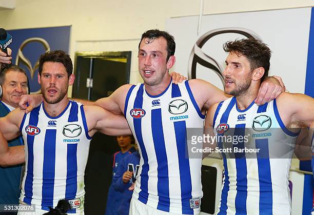 Sam Gibson of the Kangaroos, Todd Goldstein of the Kangaroos and Jarrad Waite of the Kangaroos sing the team song after winning the round eight AFL...