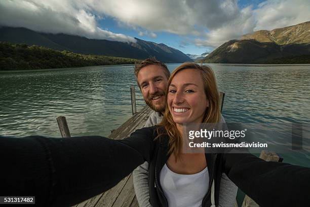 self portrait of young couple capturing vacation moments - nelson lakes national park stock pictures, royalty-free photos & images