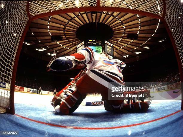 Mike Richter of the New York Rangers makes save during 1993-94 season game. Camera inside the net captures this unique angle.