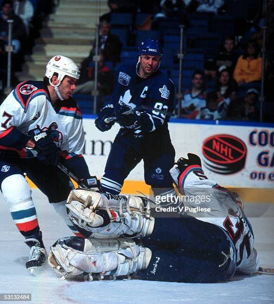 Islander goalie Tommy Salo covers up Gilmour shot as Scott LaChance comes in to help.