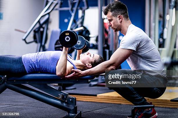 personal trainer caring woman with her workout - exercise instructor stock pictures, royalty-free photos & images