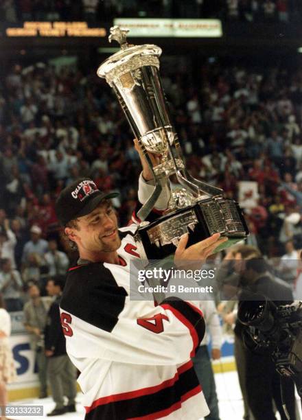New Jersey captain Scott Stevens raises the Prince of Wales trophy after the Devils defeated Philadelphia to become Eastern Conference champions and...