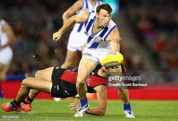 Brent Harvey of the Kangaroos is tackled during the round eight AFL match between the Essendon Bombers and the North Melbourne Kangaroos at Etihad...