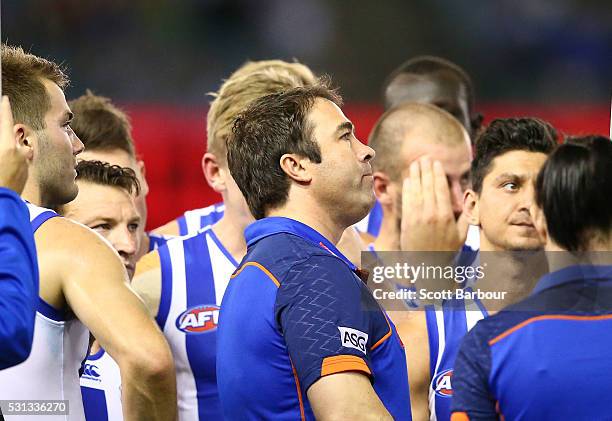 Brad Scott, coach of the Kangaroos speaks to his team during a quarter time break during the round eight AFL match between the Essendon Bombers and...