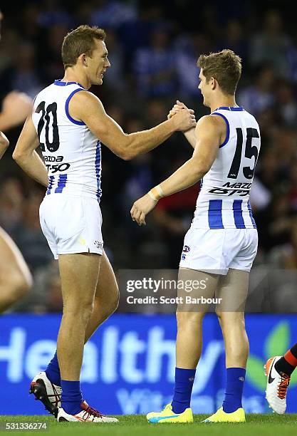 Drew Petrie of the Kangaroos celebrates after kicking a goal with Nick Dal Santo of the Kangaroos during the round eight AFL match between the...