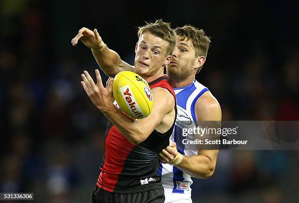 Mason Redman of the Bombers and Brad McKenzie of the Kangaroos compete for the ball during the round eight AFL match between the Essendon Bombers and...