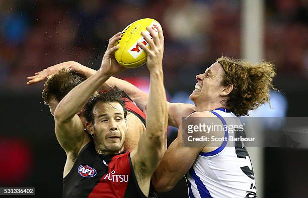 Matt Dea of the Bombers and Ben Brown of the Kangaroos compete for the ball during the round eight AFL match between the Essendon Bombers and the...
