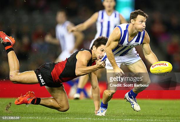 Brent Harvey of the Kangaroos is tackled during the round eight AFL match between the Essendon Bombers and the North Melbourne Kangaroos at Etihad...