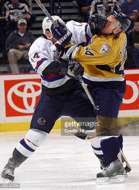 Nashville's Kimmo Timonen is stood up by Vancouver's Scott Lachance in the third period action in Nashville, Tenn.