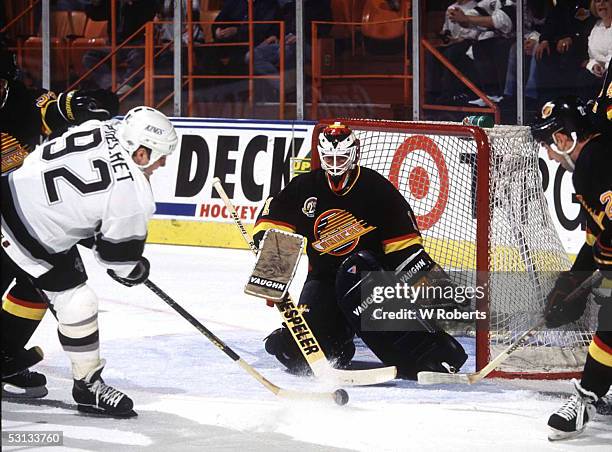 Los Angeles' Rick Tocchet fires shot on Vancouver goalie Kirk McLean.