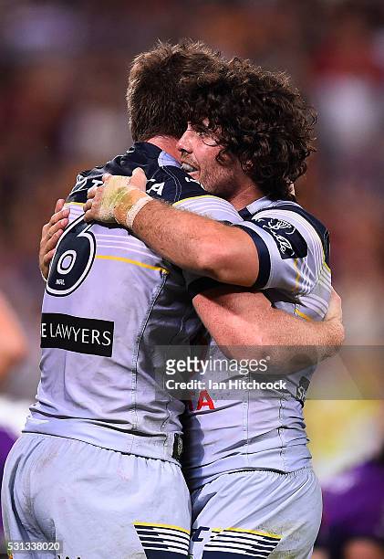 Michael Morgan of the Cowboys celebrates after scoring a try with Jake Granville during the round 10 NRL match between the Melbourne Storm and the...