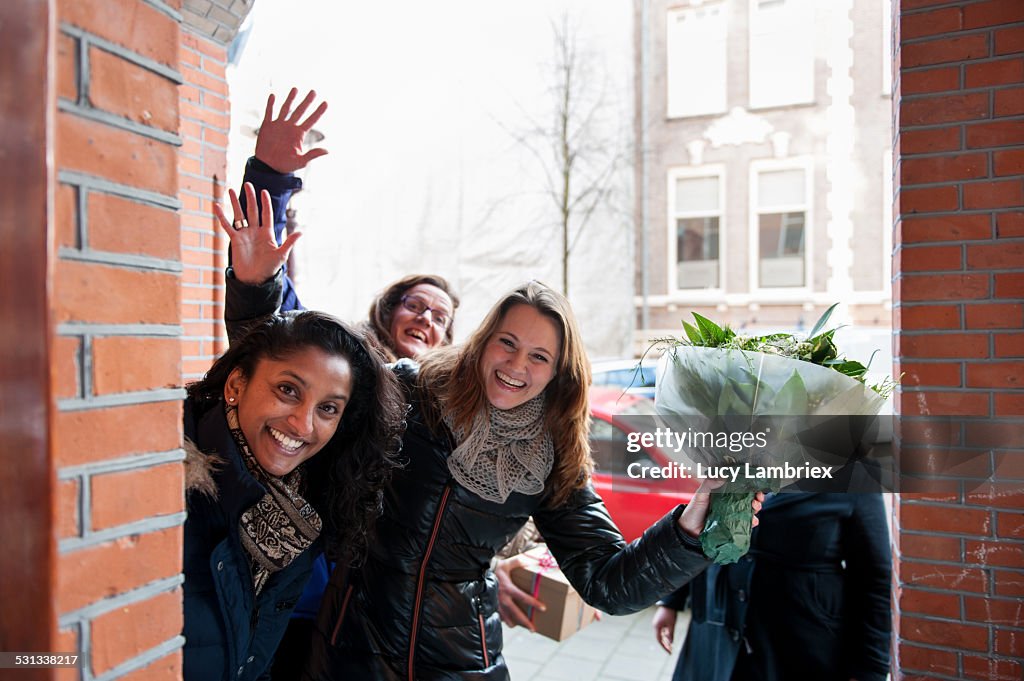 Group of women with a bunch of flowers, smiling