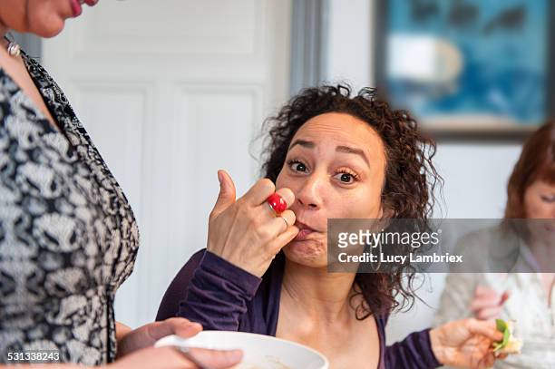 woman tasting a sauce - women licking women stock-fotos und bilder