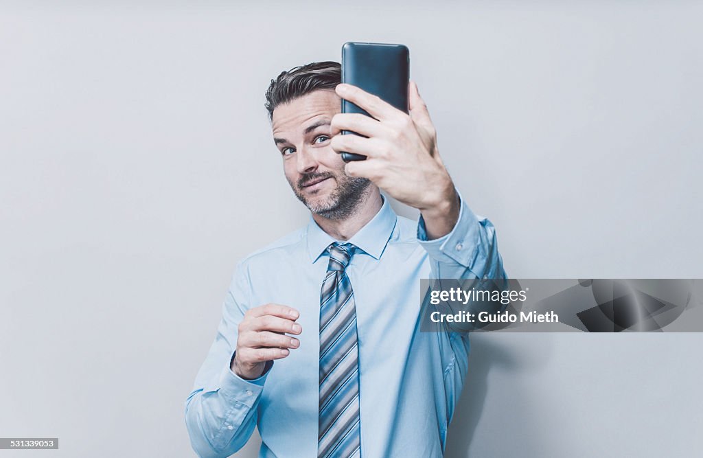 Business man doing selfie.