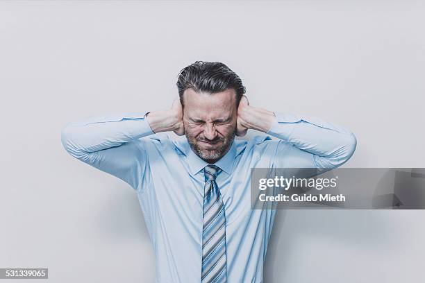 business man covering his ears. - hand to ear photos et images de collection