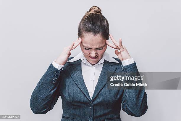 business woman with pain in head. - frowning stock pictures, royalty-free photos & images