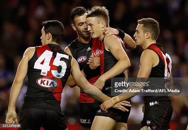 Ryan Crowley of the Bombers congratulates Mason Redman of the Bombers on a goal during the 2016 AFL Round 08 match between the Essendon Bombers and...