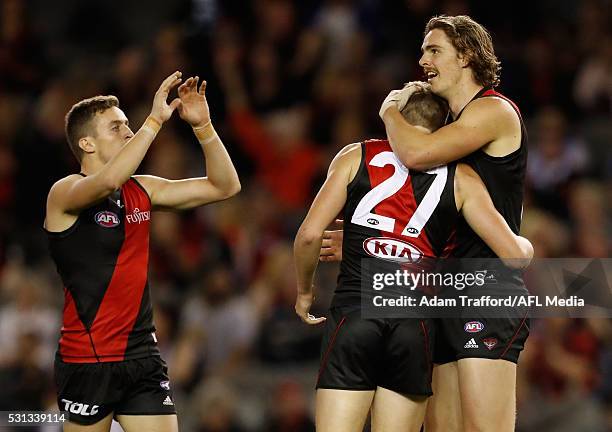 Joe Daniher of the Bombers celebrates a goal with Mason Redman and Orazio Fantasia of the Bombers during the 2016 AFL Round 08 match between the...