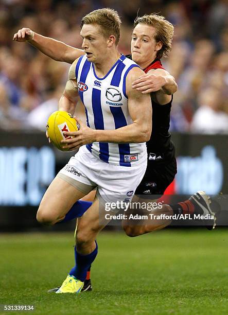 Jack Ziebell of the Kangaroos is tackled by Darcy Parish of the Bombers during the 2016 AFL Round 08 match between the Essendon Bombers and the North...