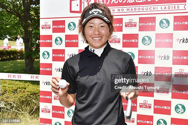 Seira Oki of Japan poses with her ball and club after making a hole-in-one on the 16th hole during the second round of the Hoken-no-Madoguchi Ladies...