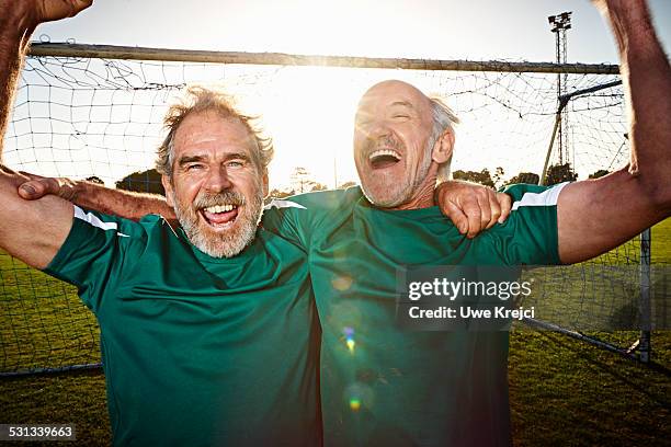 Mature soccer players cheering