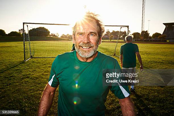portrait of mature soccer player - trikot stock-fotos und bilder