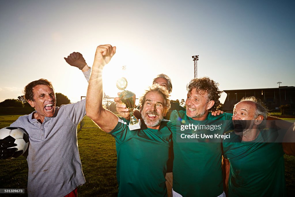 Mature soccer players celebrating