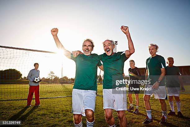 mature soccer players cheering - sports team celebration stock pictures, royalty-free photos & images