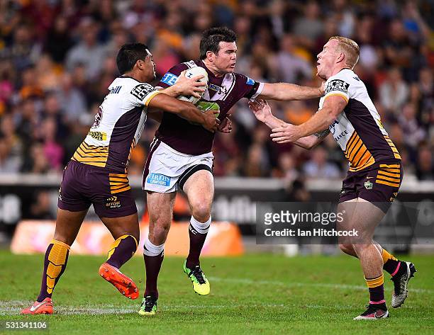 Jamie Lyon of the Sea Eagles looks to get past Anthony Milford and Jack Reed of the Broncos during the round 10 NRL match between the Manly Sea...