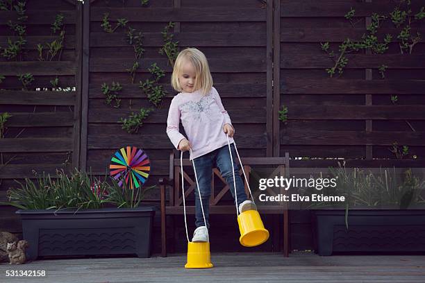 child (3-4) balancing on stilts - styltor bildbanksfoton och bilder