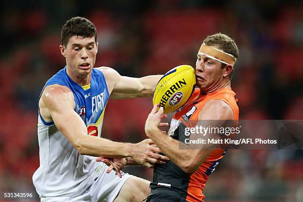 Steve Johnson of the Giants takes a mark under pressure from Henry Schade of the Suns during the round eight AFL match between the Greater Western...