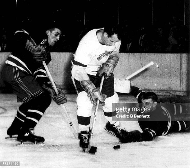 Goalie Gump Worsley of the New York Rangers stops Gordie Howe of the Detroit Red Wings during an NHL game on January 4, 1956 at the Madison Square...