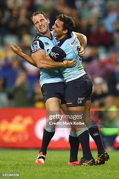 Matt Carraro and Nick Phipps of the Waratahs celebrate after Nick Phipps scored a try during the round 12 Super Rugby match between the Waratahs and...