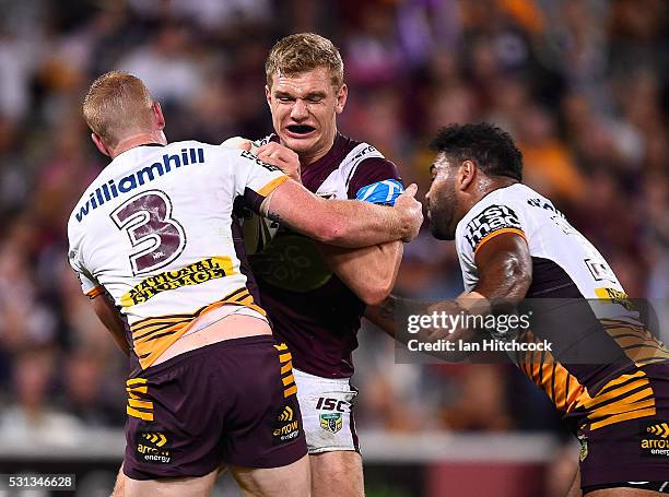 Tom Trbojevic of the Sea Eagles is tackled by Jack Reed and Sam Thaiday of the Broncos during the round 10 NRL match between the Manly Sea Eagles and...