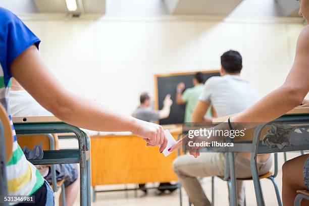 school education scene: passing information note - passing notes in school stock pictures, royalty-free photos & images