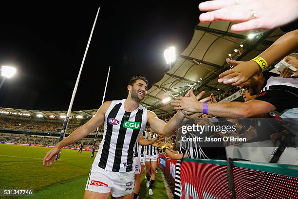 Alex Fasolo of the magpies celebrtes with fans during the round eight AFL match between the Brisbane Lions and the Collingwood Magpies at The Gabba...