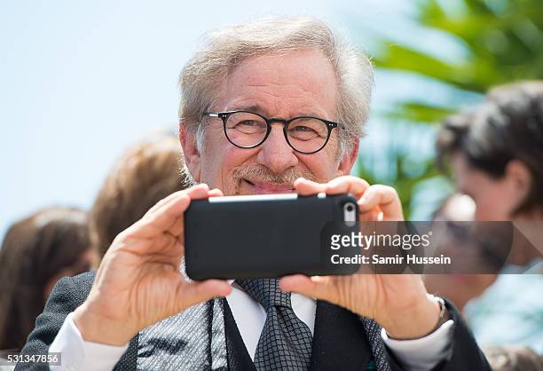 Director Steven Spielberg films on his phone as he attends "The BFG "Photocall at the annual 69th Cannes Film Festival at Palais des Festivals on May...