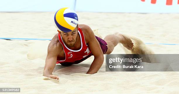 Hasan Mermer of Turkey digs for the Mikasa during the quarter final match in the 5th day of the FIVB Antalya Open beach volley tournament, May 14 in...