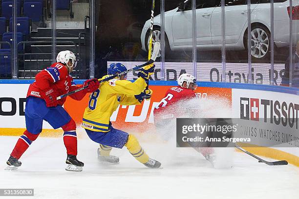 Johan Sundstrom of Sweden and Jonas Holos of Norway battle for the puck at Ice Palace on May 14, 2016 in Moscow, Russia.