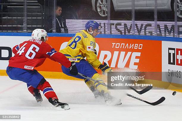 Johan Sundstrom of Sweden and Mathis Olimb of Norway battle for the puck at Ice Palace on May 14, 2016 in Moscow, Russia.